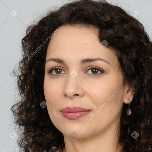 Joyful white adult female with long  brown hair and brown eyes