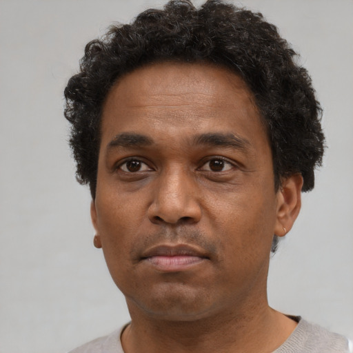Neutral black adult male with short  brown hair and brown eyes