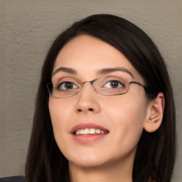 Joyful white young-adult female with long  black hair and brown eyes