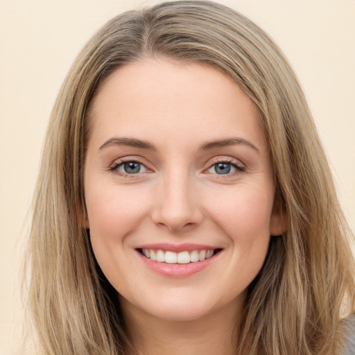 Joyful white young-adult female with long  brown hair and green eyes