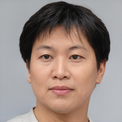 Joyful asian adult female with short  brown hair and brown eyes