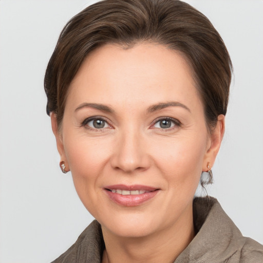 Joyful white adult female with short  brown hair and grey eyes