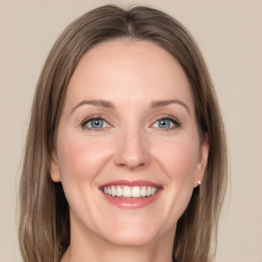 Joyful white adult female with medium  brown hair and grey eyes