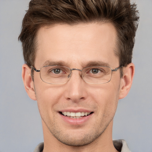 Joyful white adult male with short  brown hair and grey eyes