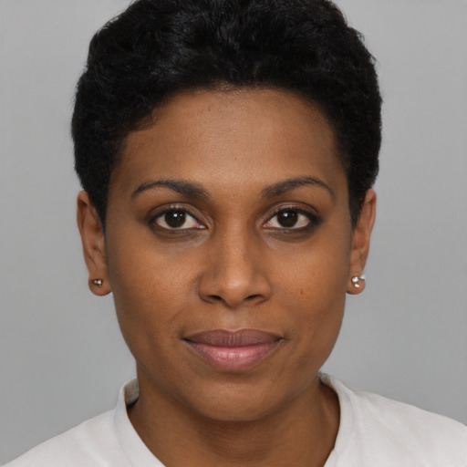 Joyful black young-adult female with short  brown hair and brown eyes