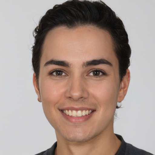 Joyful white young-adult male with short  black hair and brown eyes