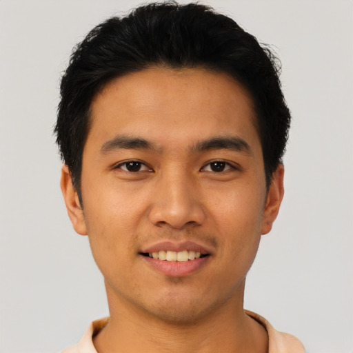 Joyful asian young-adult male with short  black hair and brown eyes