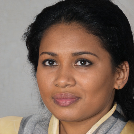 Joyful black young-adult female with medium  black hair and brown eyes