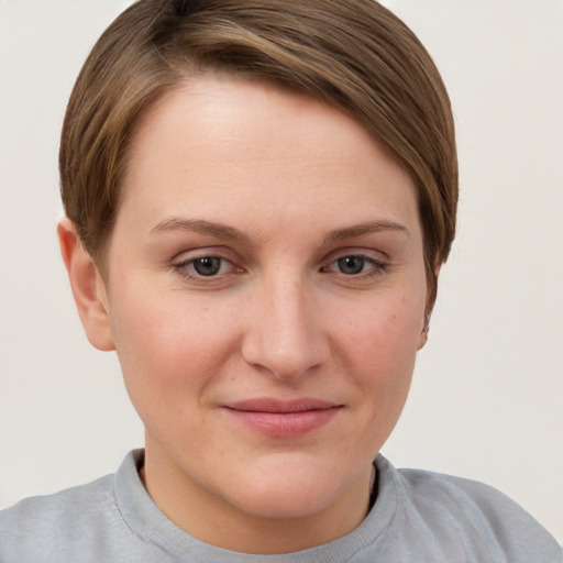 Joyful white young-adult female with short  brown hair and grey eyes