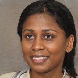 Joyful black young-adult female with medium  brown hair and brown eyes