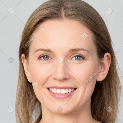 Joyful white young-adult female with long  brown hair and grey eyes