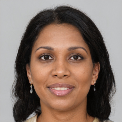 Joyful black young-adult female with medium  brown hair and brown eyes