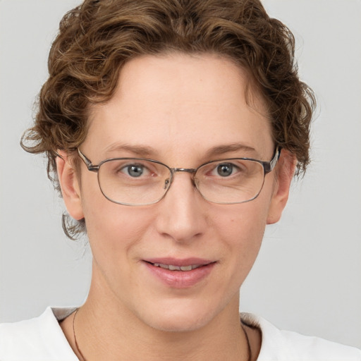 Joyful white adult female with short  brown hair and green eyes