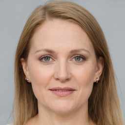 Joyful white adult female with long  brown hair and grey eyes