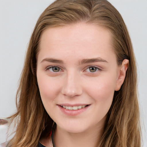 Joyful white young-adult female with long  brown hair and blue eyes