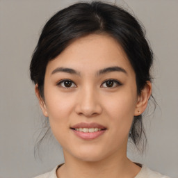 Joyful asian young-adult female with medium  black hair and brown eyes