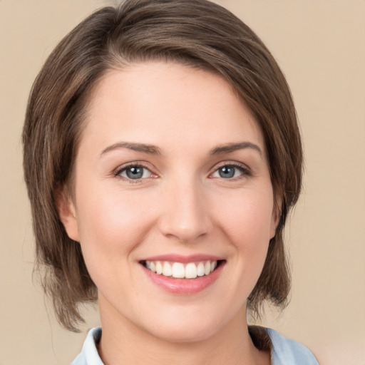 Joyful white young-adult female with medium  brown hair and green eyes