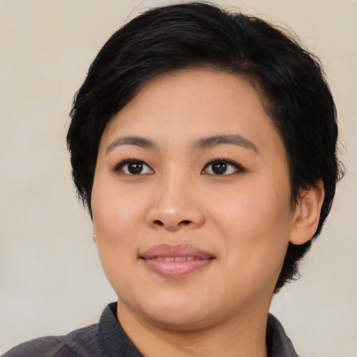 Joyful asian young-adult female with medium  black hair and brown eyes