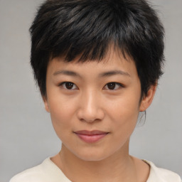 Joyful asian child female with short  brown hair and brown eyes