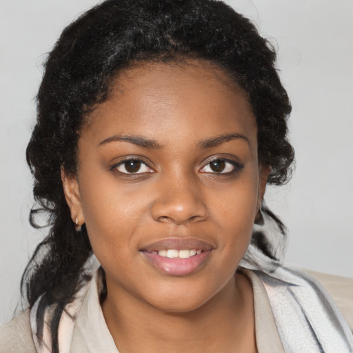 Joyful black young-adult female with medium  brown hair and brown eyes