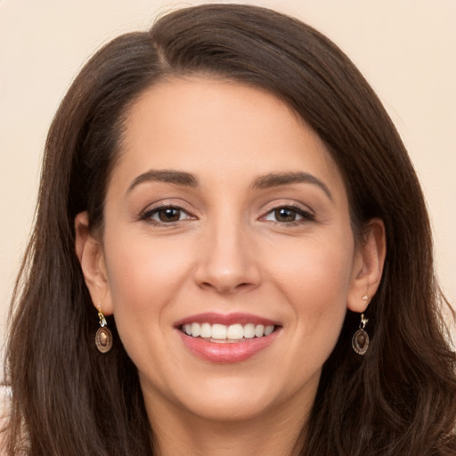 Joyful white young-adult female with long  brown hair and brown eyes