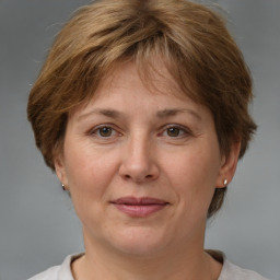 Joyful white adult female with medium  brown hair and brown eyes