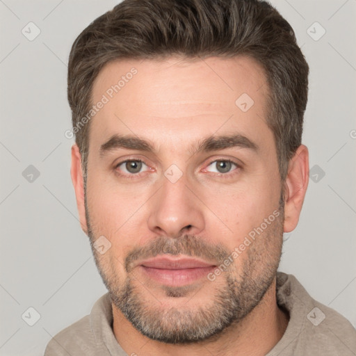 Joyful white adult male with short  brown hair and brown eyes