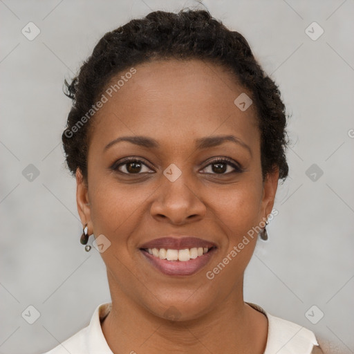 Joyful black young-adult female with short  brown hair and brown eyes