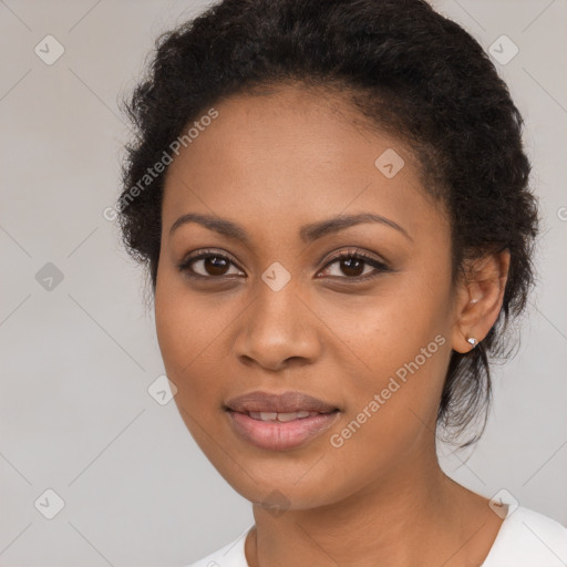 Joyful black young-adult female with long  brown hair and brown eyes