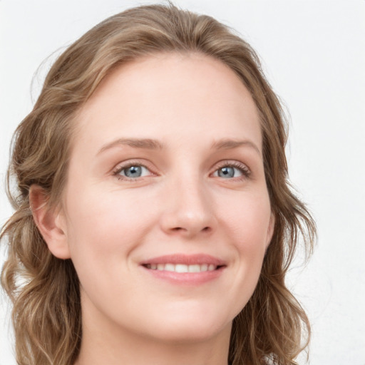 Joyful white young-adult female with long  brown hair and blue eyes