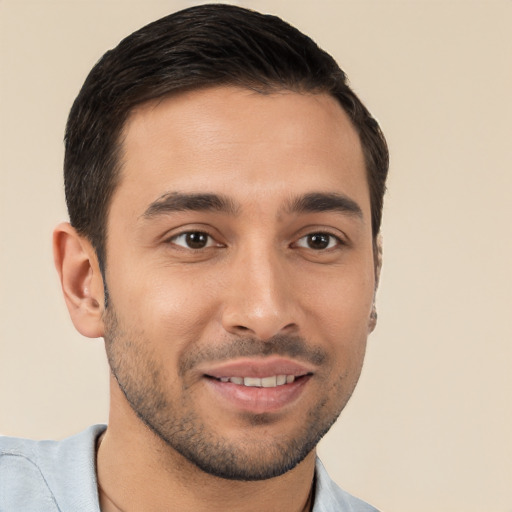 Joyful white young-adult male with short  black hair and brown eyes