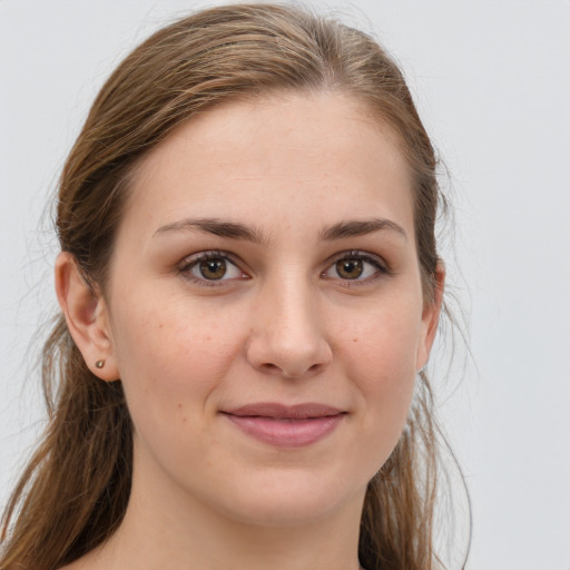 Joyful white young-adult female with long  brown hair and grey eyes