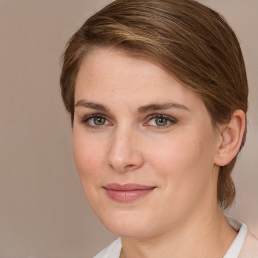 Joyful white young-adult female with medium  brown hair and grey eyes