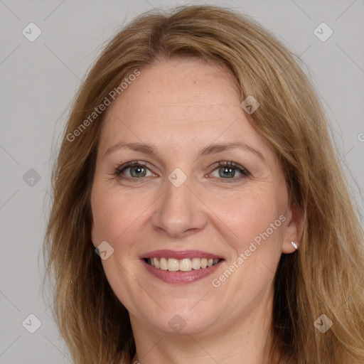 Joyful white adult female with long  brown hair and grey eyes