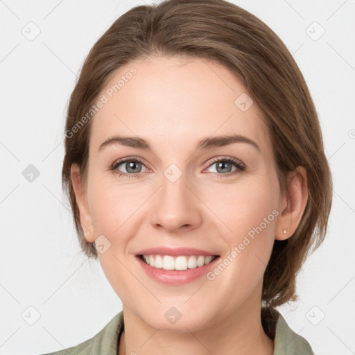 Joyful white young-adult female with medium  brown hair and grey eyes