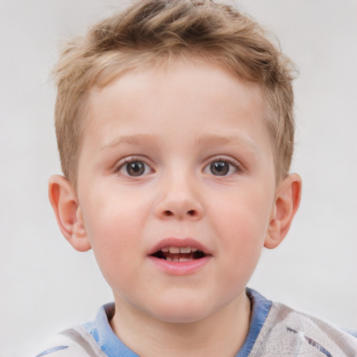 Joyful white child male with short  brown hair and blue eyes