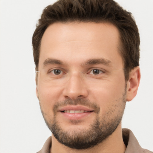 Joyful white young-adult male with short  brown hair and brown eyes