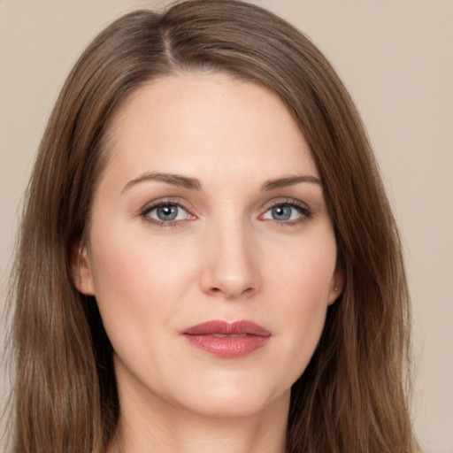 Joyful white young-adult female with long  brown hair and grey eyes