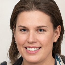 Joyful white young-adult female with medium  brown hair and grey eyes