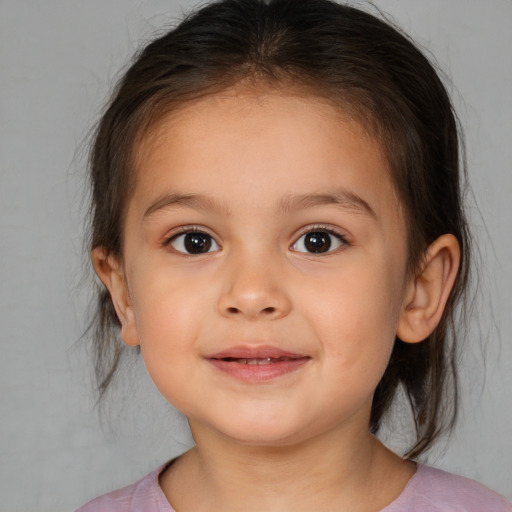 Joyful white child female with medium  brown hair and brown eyes