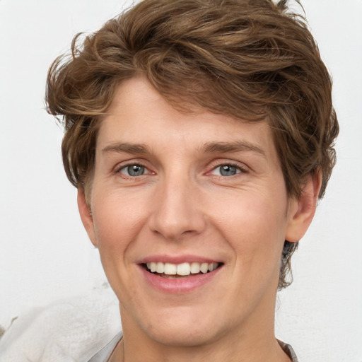 Joyful white adult male with medium  brown hair and grey eyes