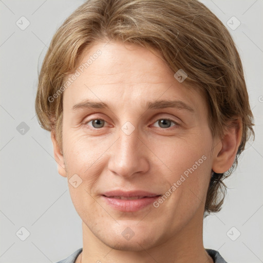 Joyful white young-adult female with short  brown hair and grey eyes