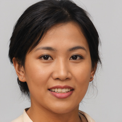 Joyful asian young-adult female with medium  brown hair and brown eyes