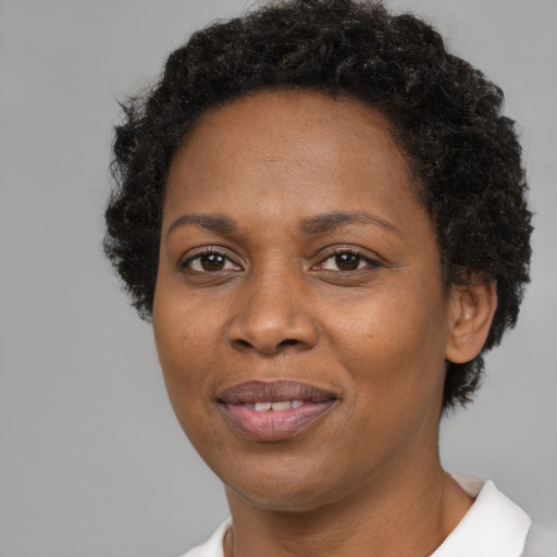 Joyful black adult female with short  brown hair and brown eyes