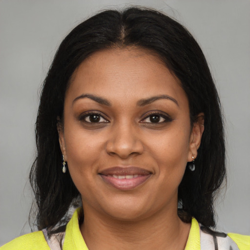 Joyful black young-adult female with medium  brown hair and brown eyes
