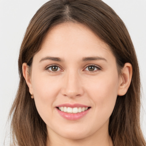 Joyful white young-adult female with long  brown hair and brown eyes