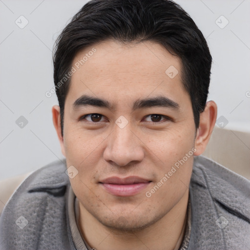 Joyful asian young-adult male with short  brown hair and brown eyes