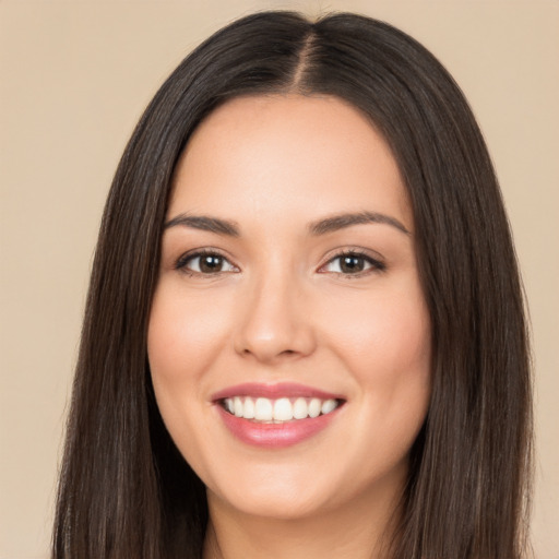 Joyful white young-adult female with long  black hair and brown eyes