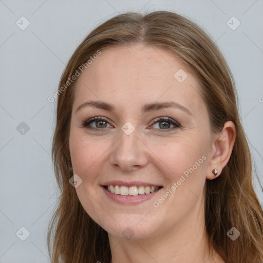 Joyful white young-adult female with long  brown hair and grey eyes