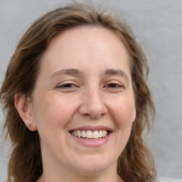 Joyful white adult female with medium  brown hair and brown eyes